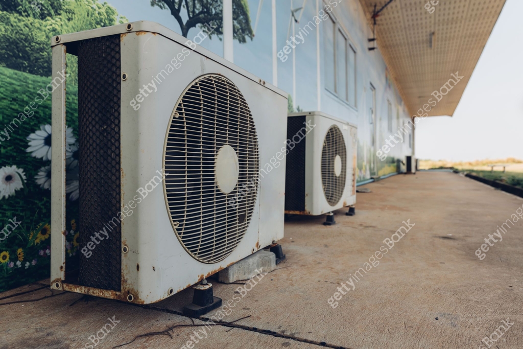 Air conditioner compressor installed in old building. Outdoor split ...