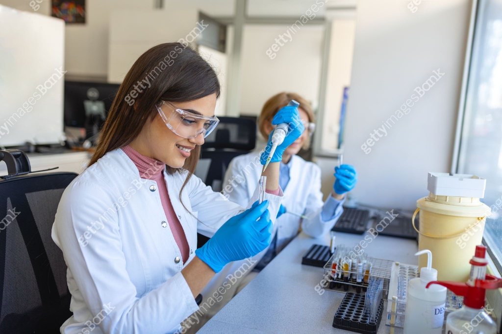 Female Medical Research Scientist Looks at Biological Samples Before ...