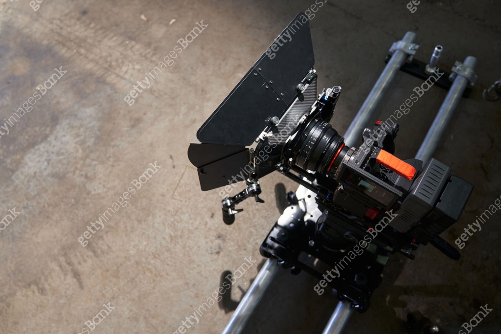 on the camera trolley and rails there is a professional movie camera ...