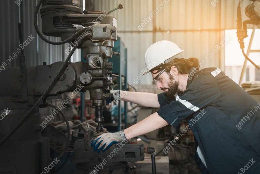 Industrial engineers inspect and perform maintenance on the machines at ...
