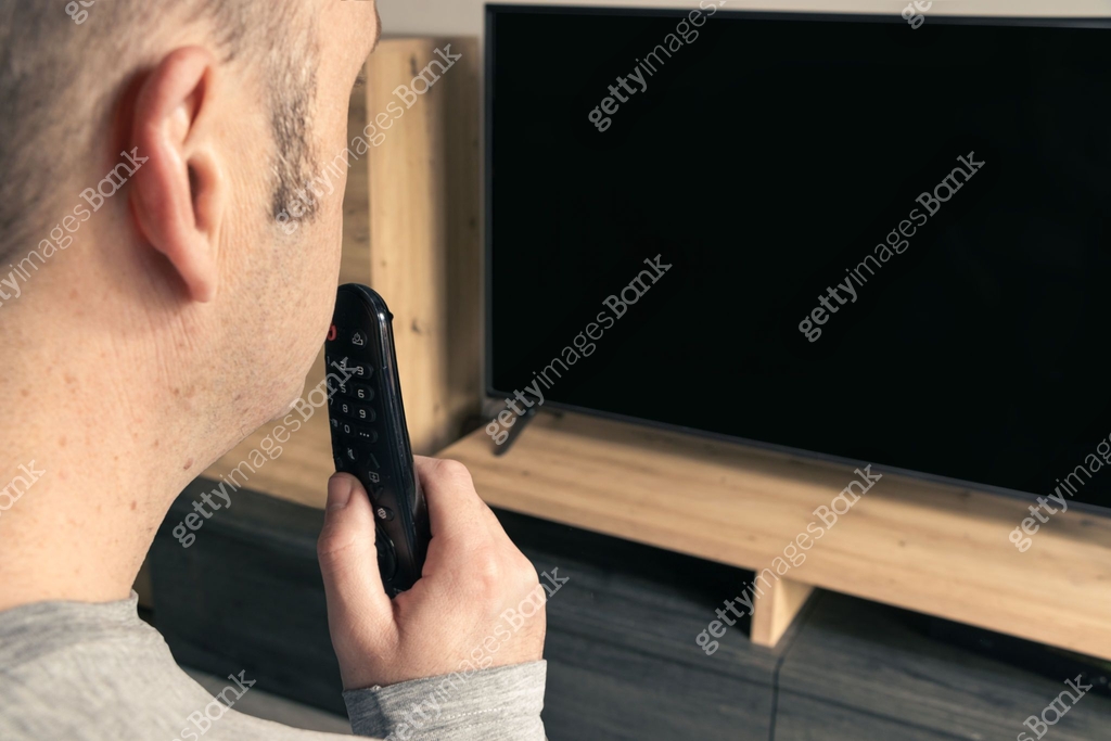 Man Using Remote young man using tv remote with voice 이미지 (1459345552) - 게티이미지뱅크