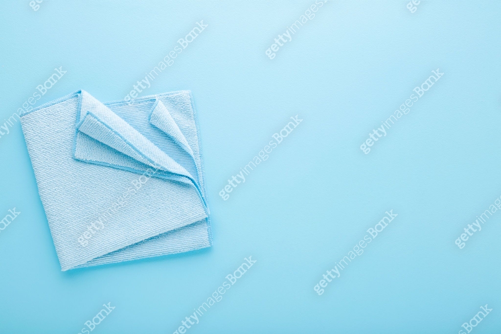 Folded dry soft microfiber rag for different surfaces wiping on light ...