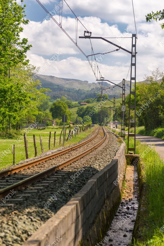 The iron rails are covered with rubble. Bright landscape with a railway ...