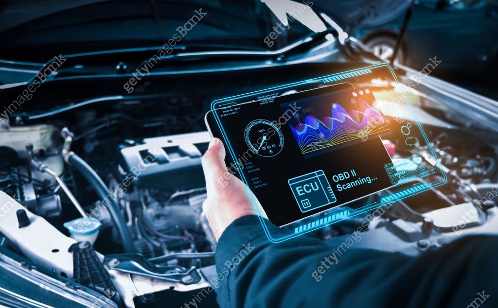 Auto mechanic checking ECU engine system with OBD2 wireless scanning ...