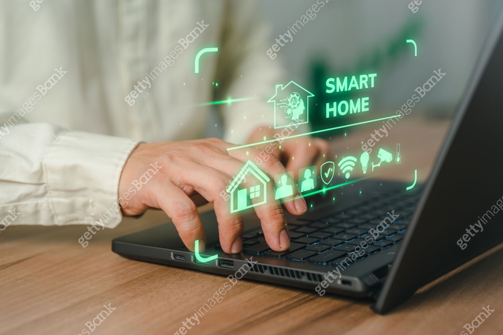 Adult man controlling technology AI smart home devices using a laptop ...