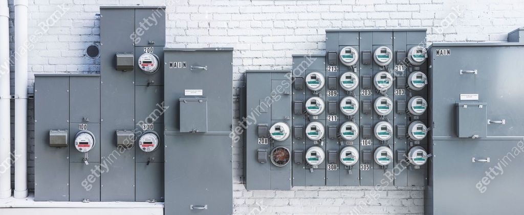 Array of electric meters on the brick wall. Power supply and energy ...