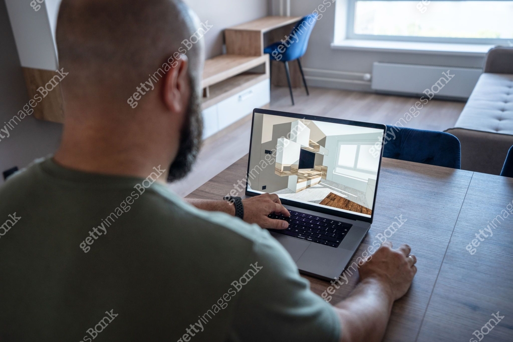 Interior designer examines 3d model of apartment by a laptop. Same ...