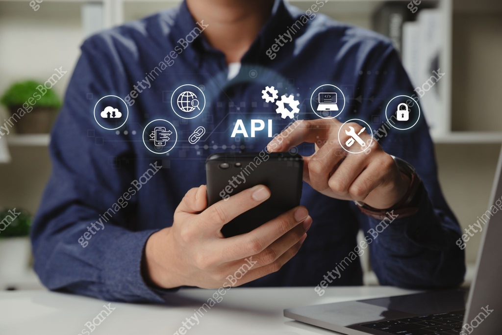 Smartphone Programmer Hands of programmer and smartphone with API or Application Program ...
