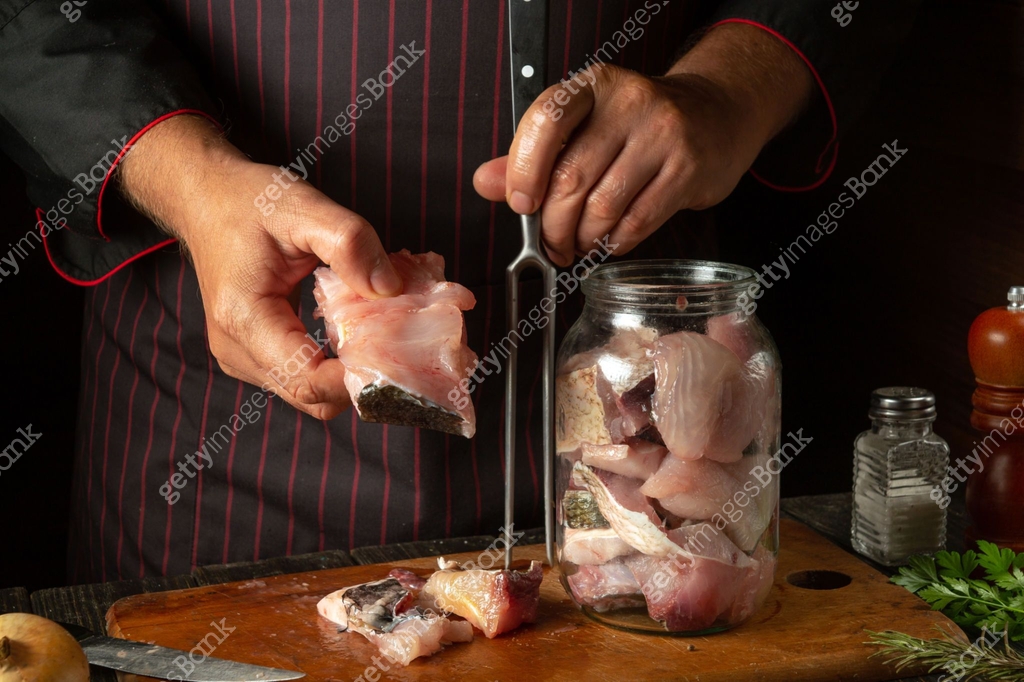 The chef prepares fresh bighead carp fish. Getting ready to cook or ...
