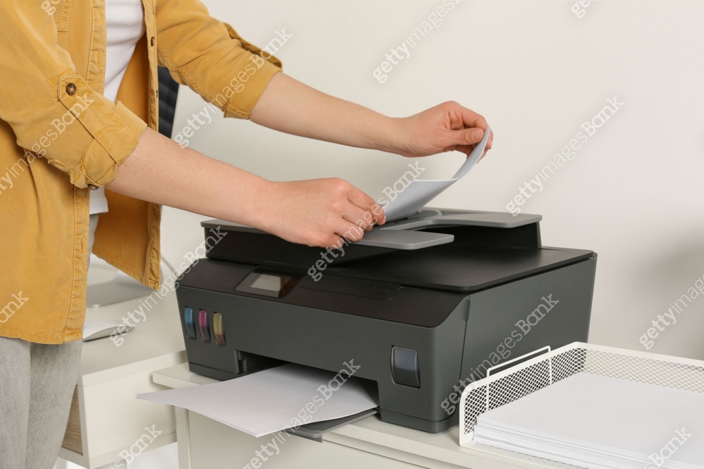 Someone Using The Printer Woman using modern printer at home, closeup 이미지 (1709001077) - 게티이미지뱅크