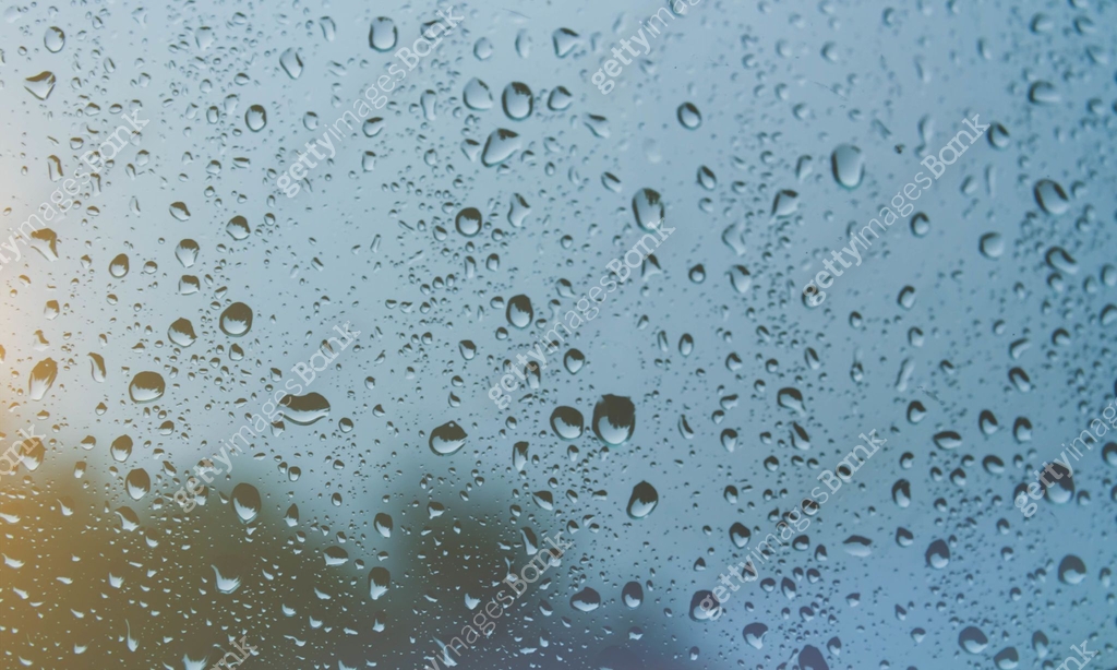 Glass Raning Sun after rain. Drops on glass. It's been raining. Texture on glass ...