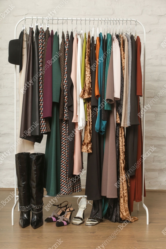 Women's clothes and shoes. Clothes rack with stylish and elegant ...