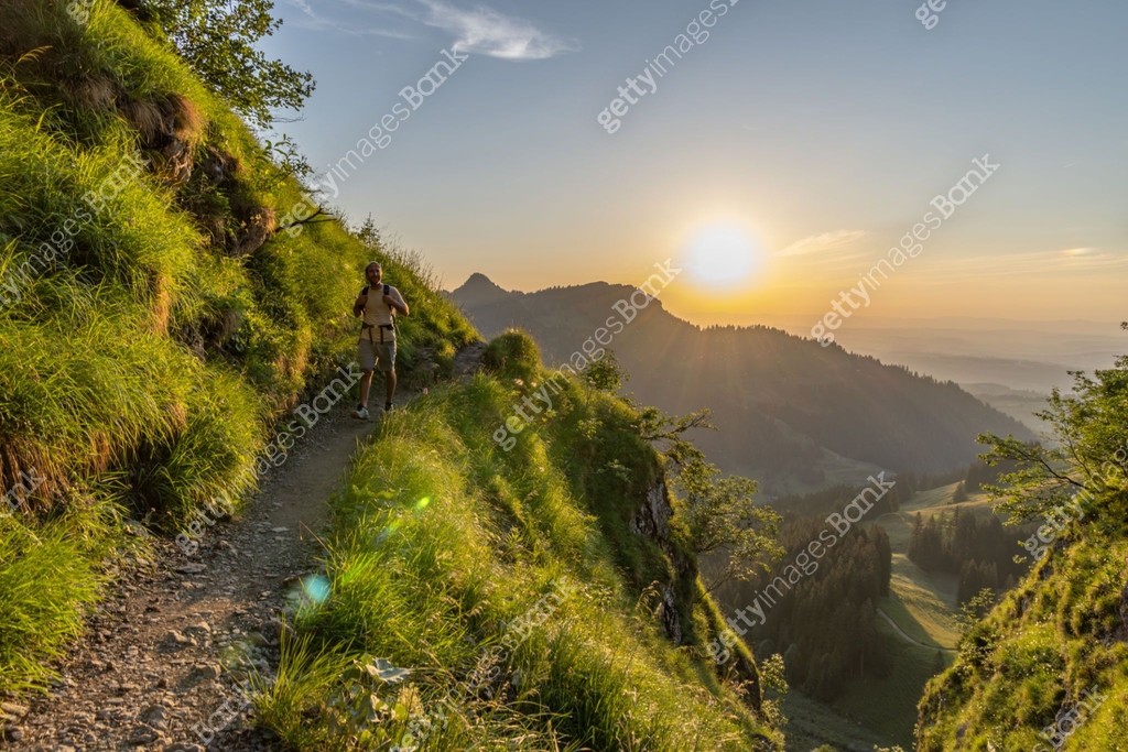 Man Making Ridge Forest Man hikes along grassy mountain ridge at sunrise 이미지 (1727281384) - 게티이미지뱅크
