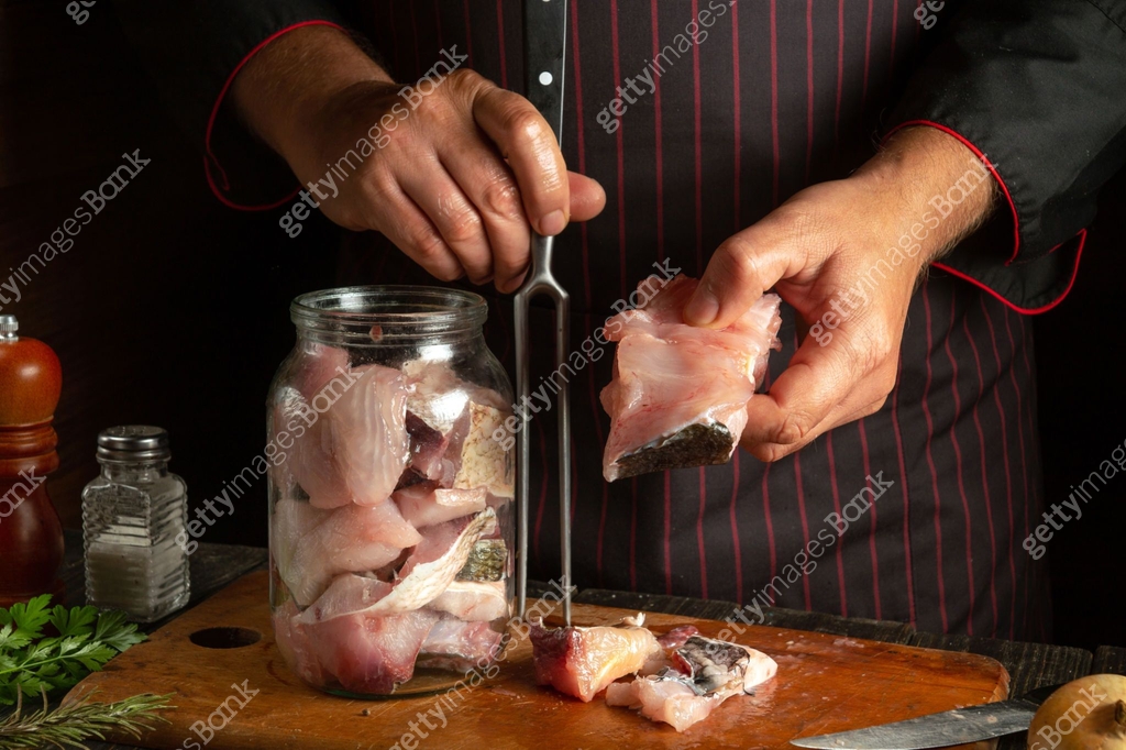 The chef prepares fresh bighead carp fish. Getting ready to cook or ...