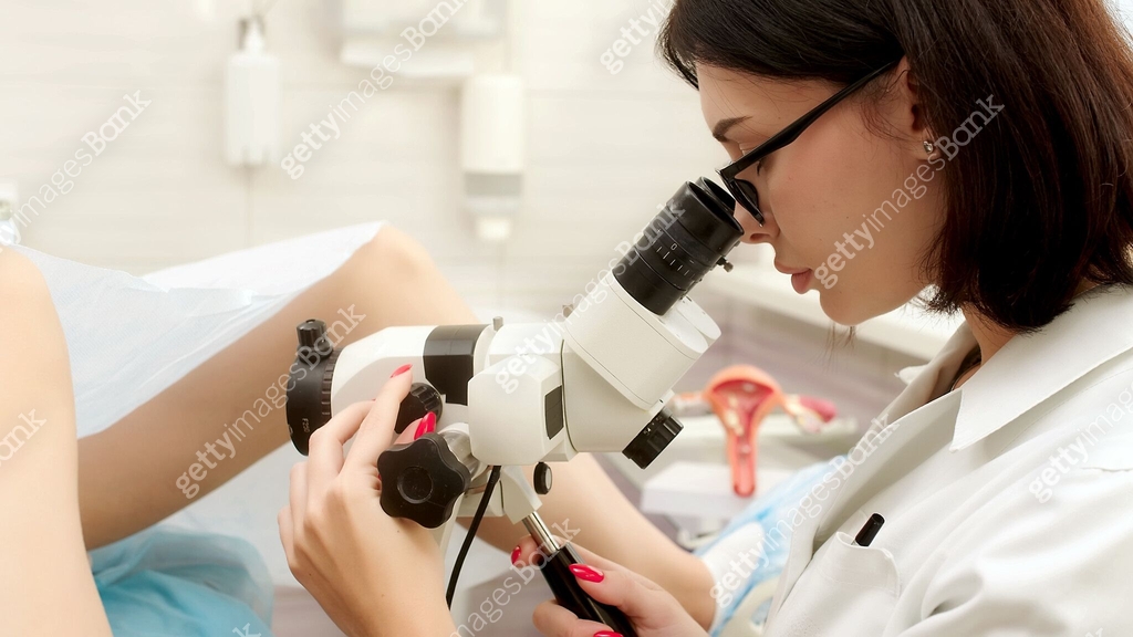 Patient and doctor in a gynecological office during a colposcopy ...