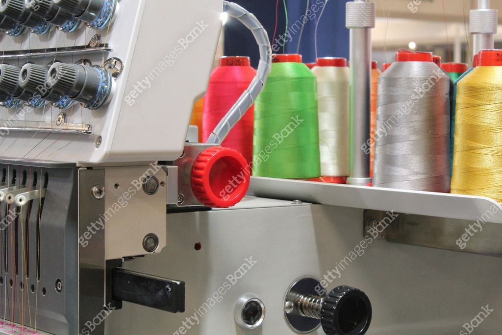 Cloth Thread Making Machine Close-up of spools of color threads, spinning machine. Yarn bobbins ...