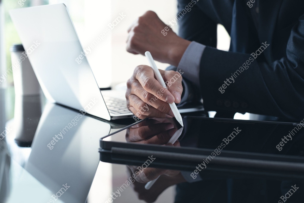 Businessman using stylus pen signing e-document on digital tablet with ...