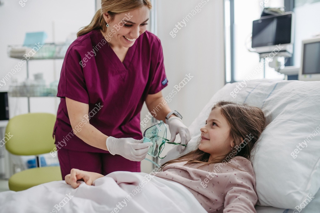Friendly Nurse Putting Oxygen Mask On Little Patient Face Cute Girl friendly-nurse-putting-oxygen-mask-on-little-patient-face-cute-girl
