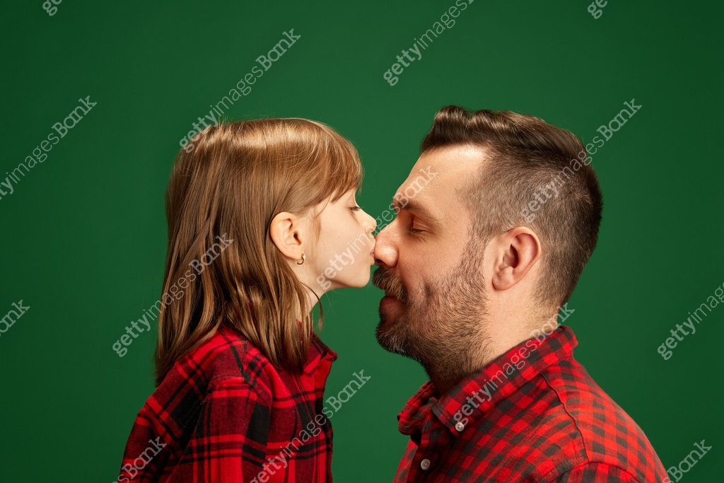 Little Girl Kid Kisses Father s Nose Expressing Love Against Green little-girl-kid-kisses-father-s-nose-expressing-love-against-green