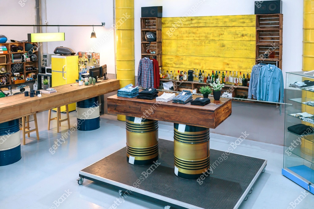 Interior of empty clothing store with clothes on counter over fuel ...
