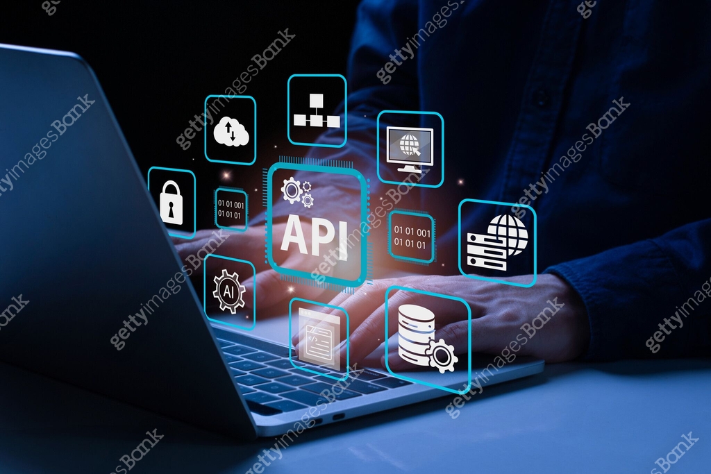 API, Application Programming Interface concept. A man using laptop with ...