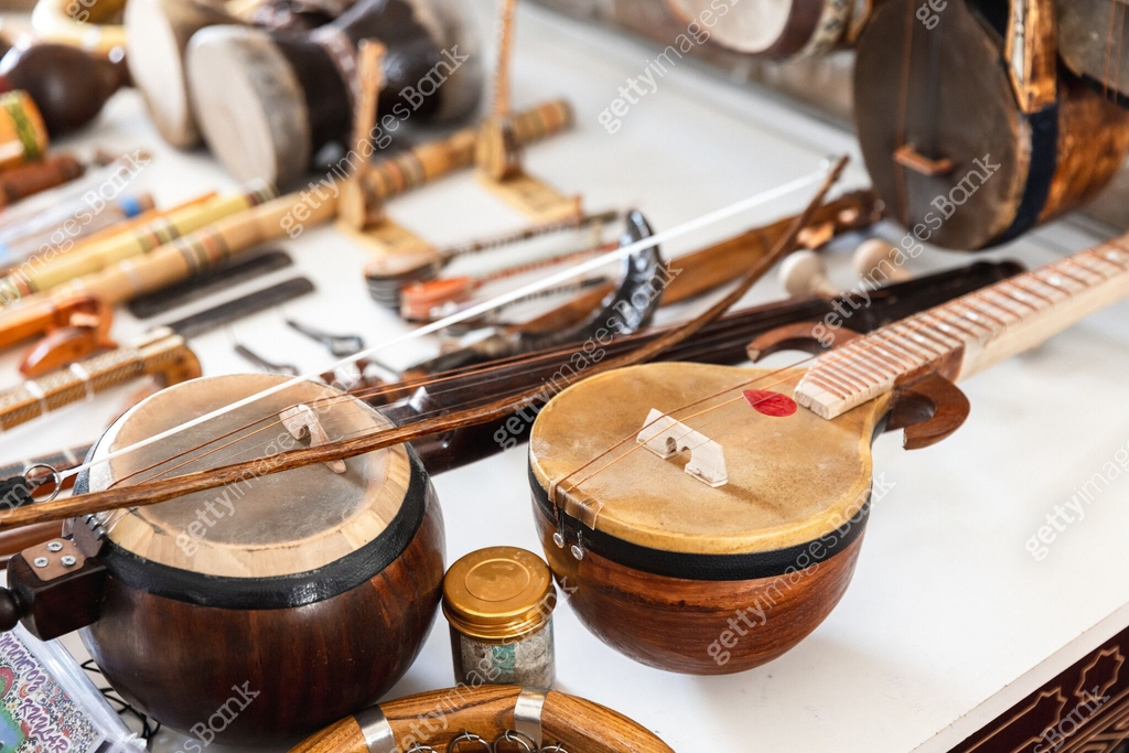 Central Asian stringed musical instruments are put up for sale at a ...