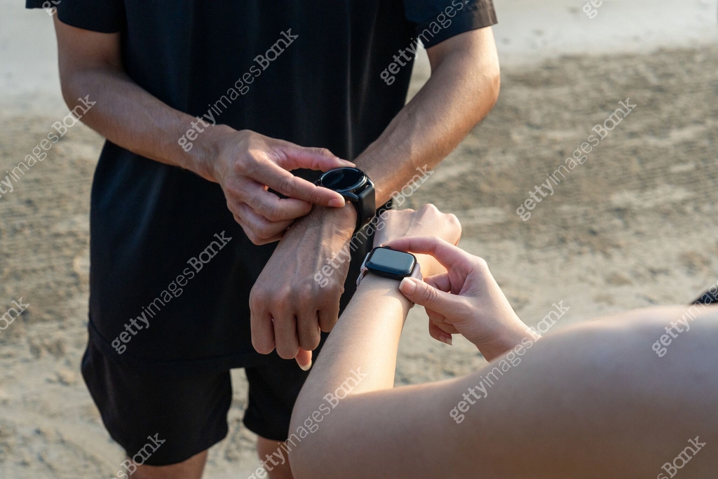Someone Using A Smart Watch Sporty people using smart watch showing heart rate monitor. Technology ...