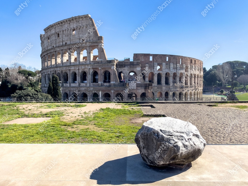 Colosseum Rome Rocks A rock sits on the Roman forum facing perfect view of the ancient Roman ...