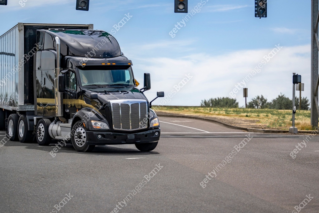 Big Rigs Shiny Shiny black big rig semi truck transporting cargo in dry van semi ...