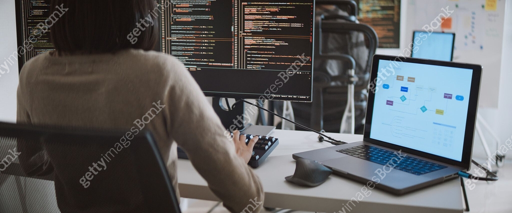 Young adult Asian male, female software developer coding program on ...