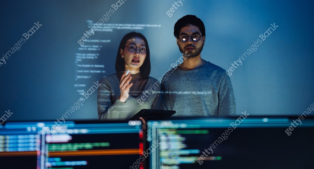 Asian Two software developers engaged in collaborative coding session ...