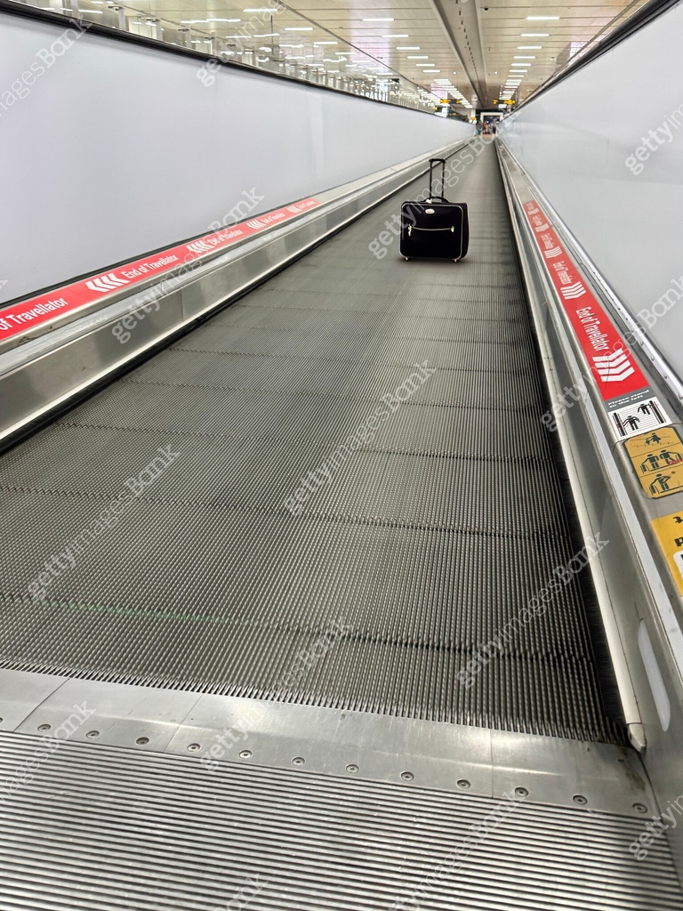 Image of black airplane luggage standing travelling on travelator ...