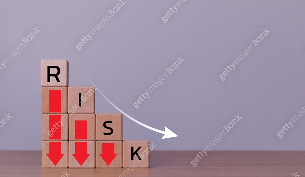 Risk wording on decreasing coins stacking with down arrow for financial ...