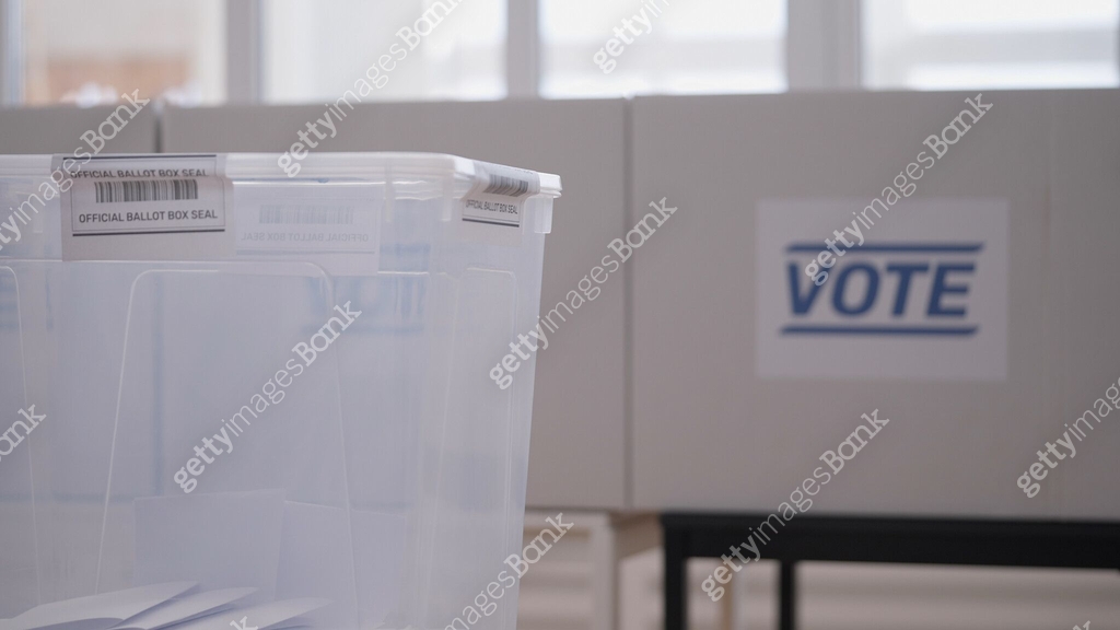 Polling station with voting booths and a ballot box waiting for voters ...