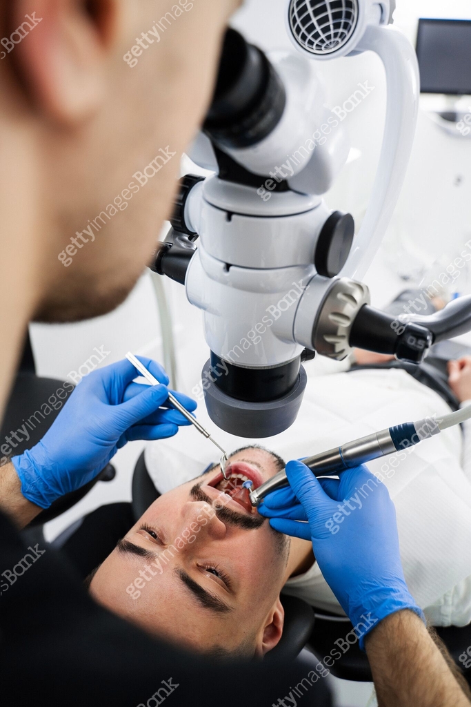 Microscope Operation Process Dentist uses operating microscope to polish teeth of the patient ...