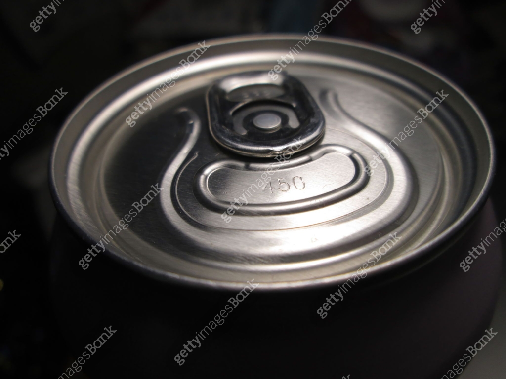 A vivid close-up of a beverage cans lid showcases the pull tab and its ...