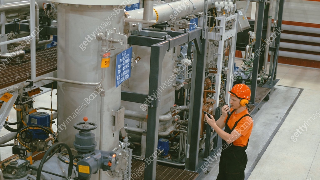 In oil and gas site, compressor operator manages machinery performance ...