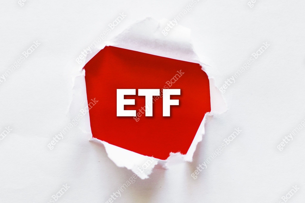 Torn paper with ETF message, Exchange Traded Fund stock market concept ...