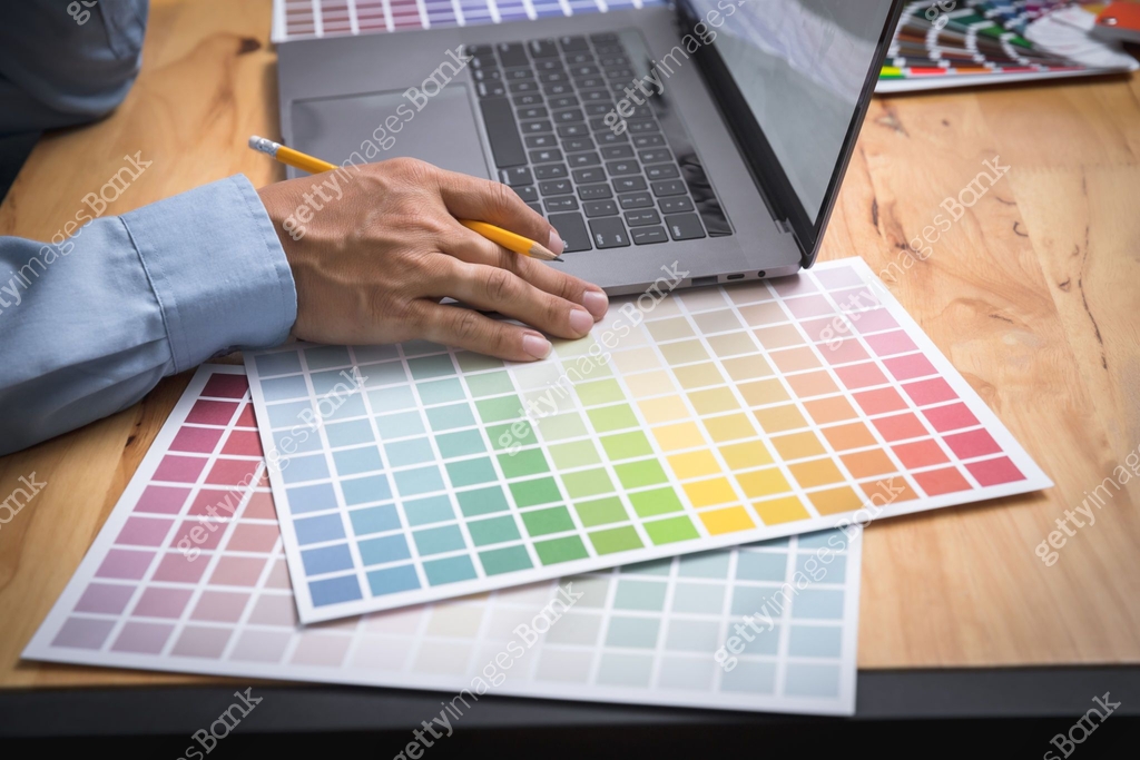 Photographer Graphist designer working on a laptop with colors chart ...