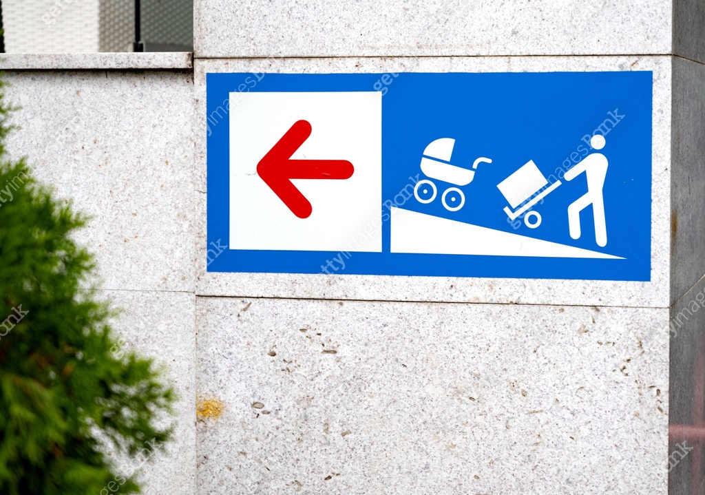 Stroller Ramp Sign Sign with a red left arrow and icons showing a person with a cart and ...