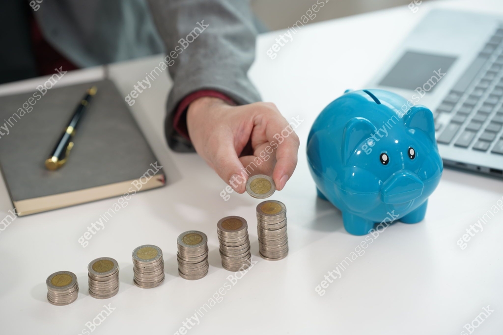 Coin Save A person who puts coins in a piggy bank to save money and invest for ...