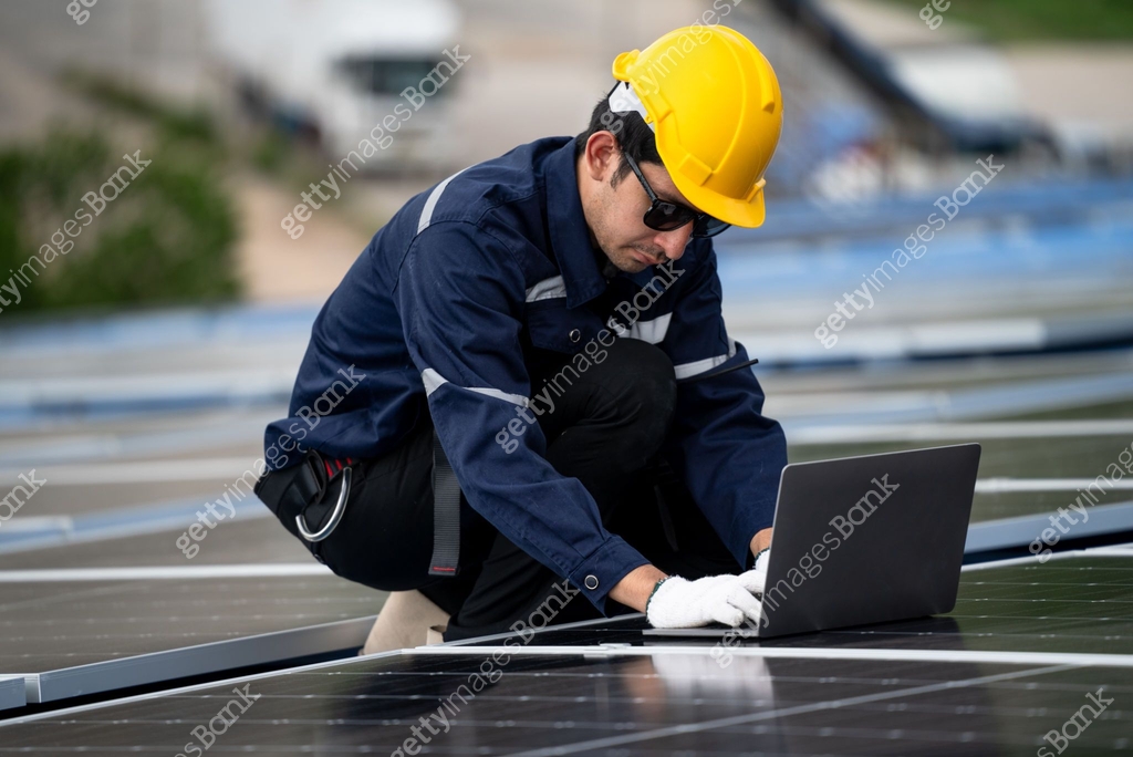 Engineer using computer laptop checking and working on solar cell or ...
