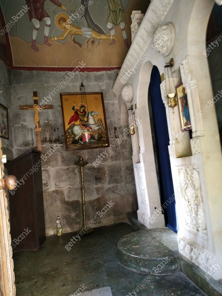 A serene corner of an ancient church with religious iconography and ...
