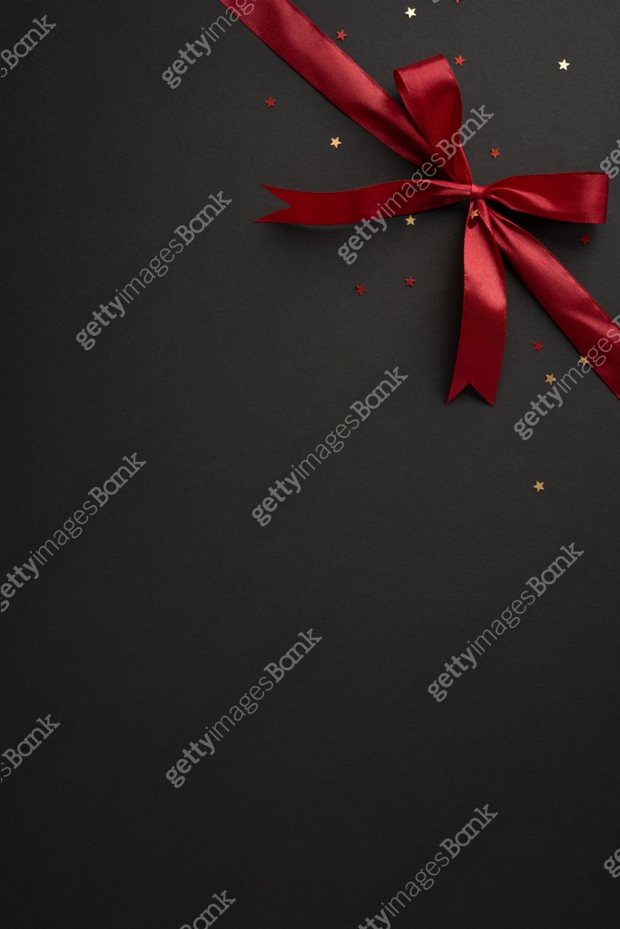 Bow Backdrop Computer Red A stylish vertical red ribbon bow adorns a black backdrop, scattered ...