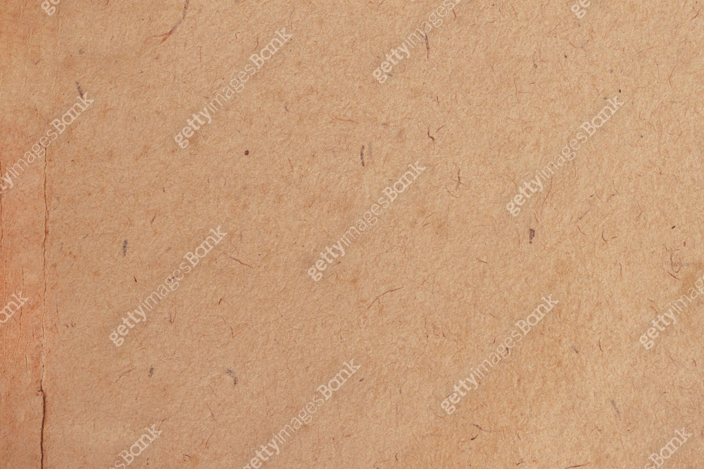 Rough textured brown paper with visible fibrous details, creating ...