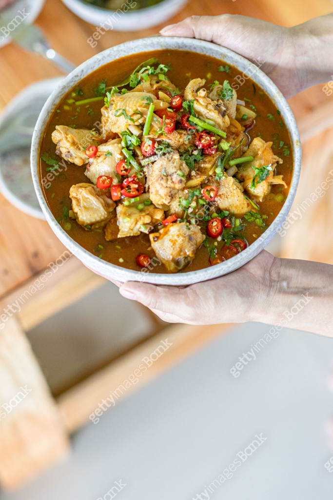 Spicy stir fried chicken served in dish is native chicken that is ...